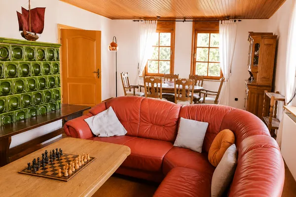 Gemütliches Wohnzimmer mit Kachelofen und Ledersofa